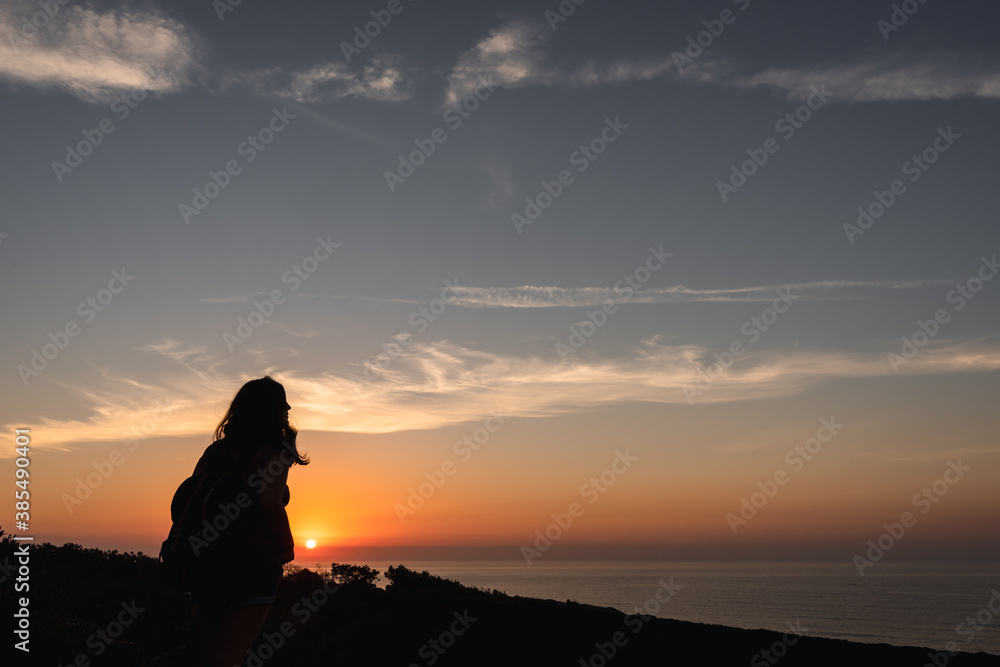 Silhouette of a woman on a sunset background Silhouette of a woman on a sunset background
