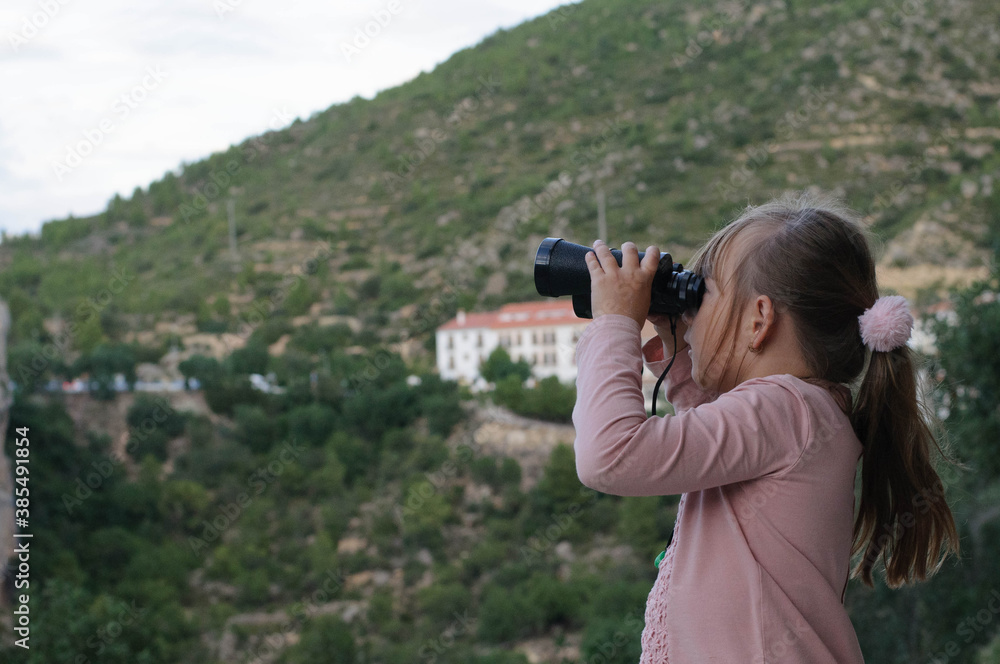 girl with binoculars on the background of the mountain girl with binoculars on the background of the mountain