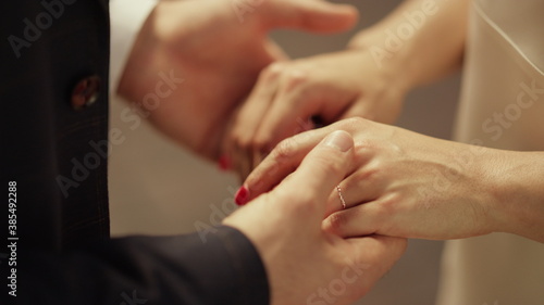 Young man and woman holding hands. Unknown newlywed couple just married