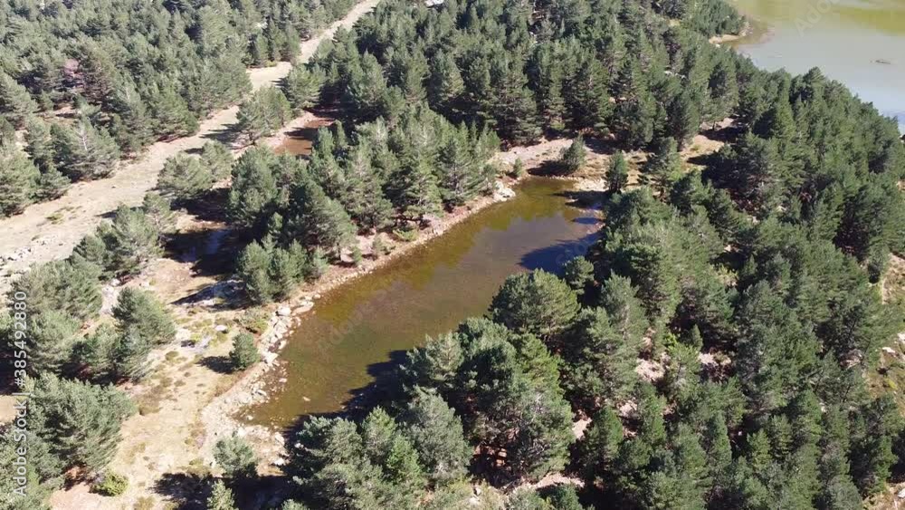 aerial shot of a small lagoon on the mountains in Neila, Spain aerial shot of a small lagoon on the mountains in Neila, Spain