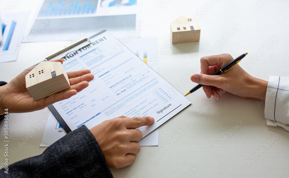 Fototapeta premium Close up of Hands Business woman signature on contract to buy or sell real estate.