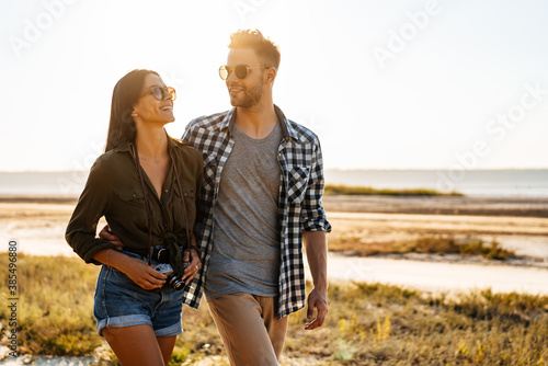 Photography Beautiful happy couple hugging and smiling while strolling on nature