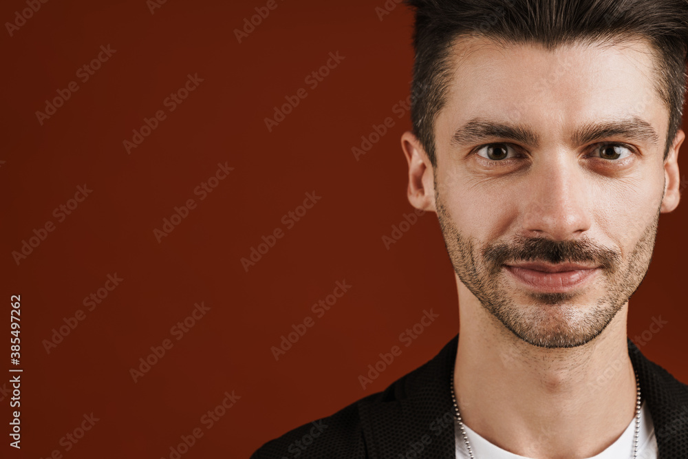Photo of joyful handsome man smiling and looking at camera Photo of joyful handsome man smiling and looking at camera