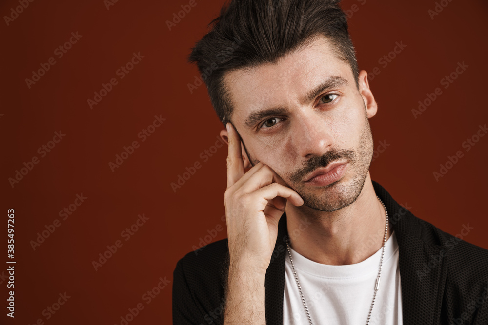 Photo of confident man looking at camera and touching his temple Photo of confident man looking at camera and touching his temple