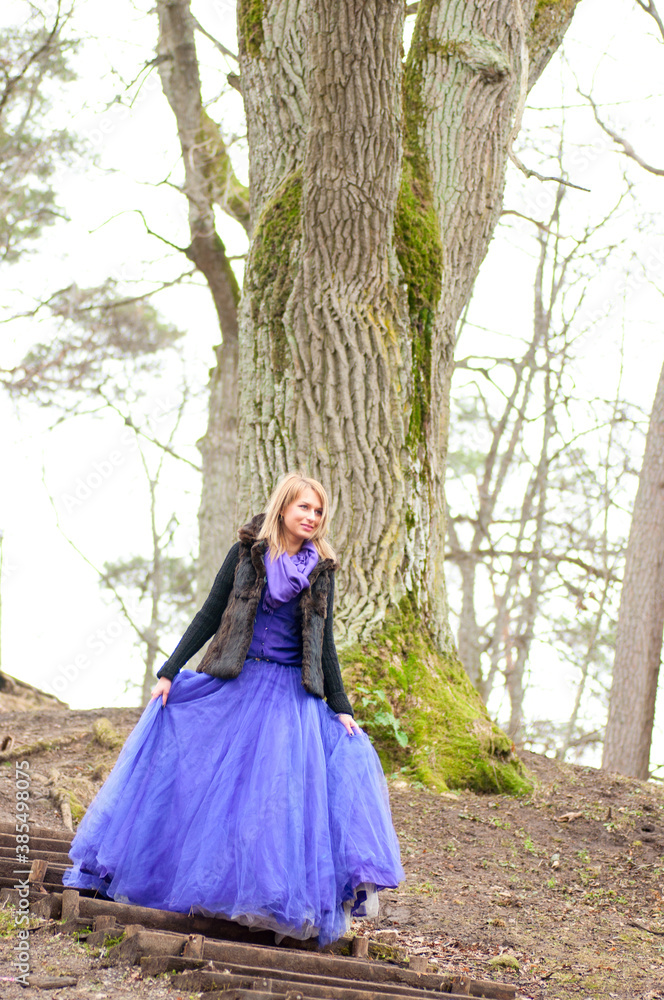 woman in forest with violet dress woman in forest with violet dress