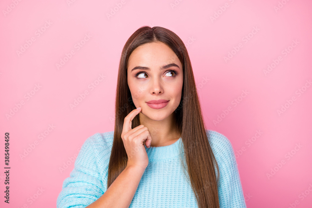 Closeup photo of attractive lady dreamer look side empty space hand on chin creative person wear knitted blue sweater isolated pastel pink color background Closeup photo of attractive lady dreamer look side empty space hand on chin creative person wear knitted blue sweater isolated pastel pink color background
