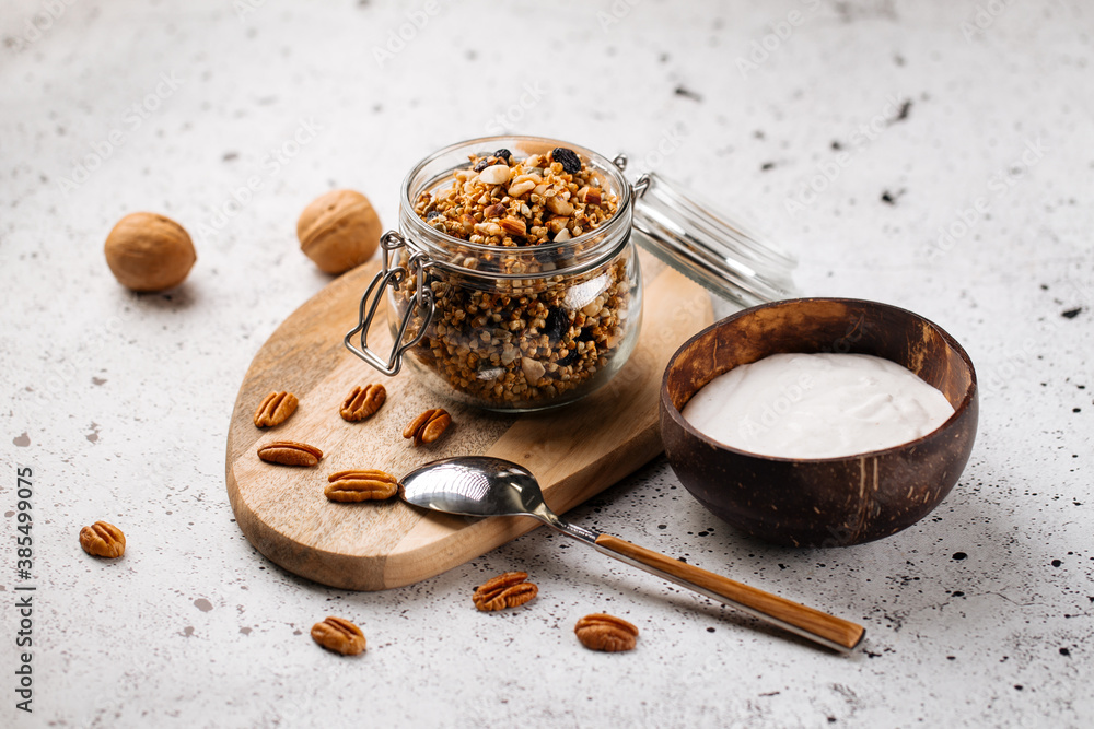 Fototapeta premium Breakfast yogurt in wooden bowl with granola