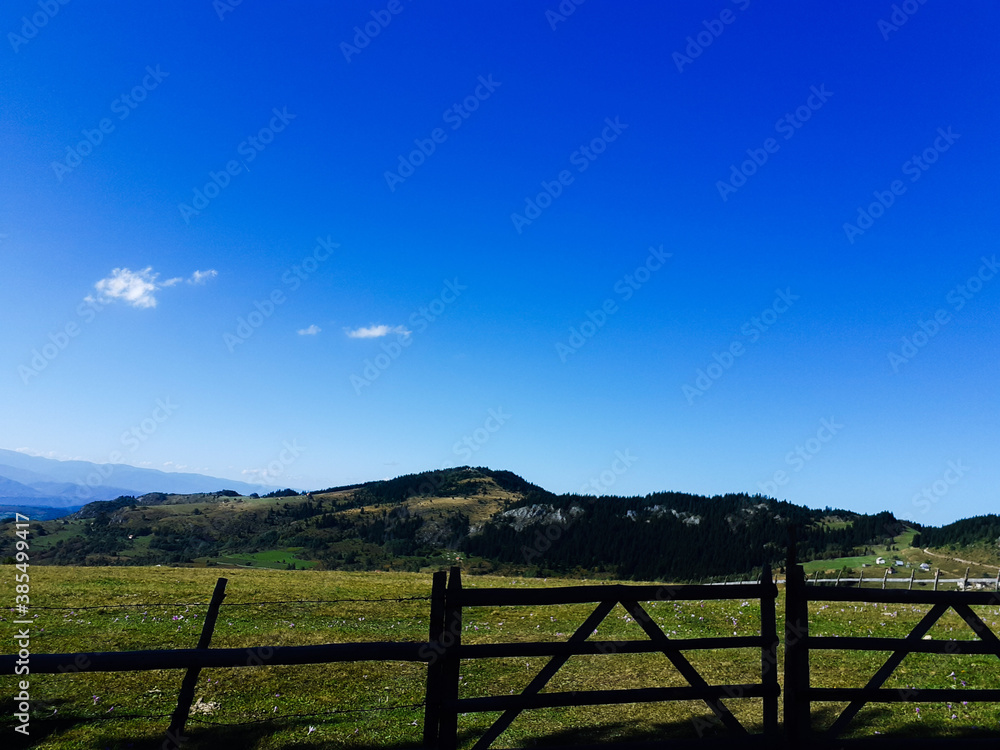 landscape with fence and blue sky
