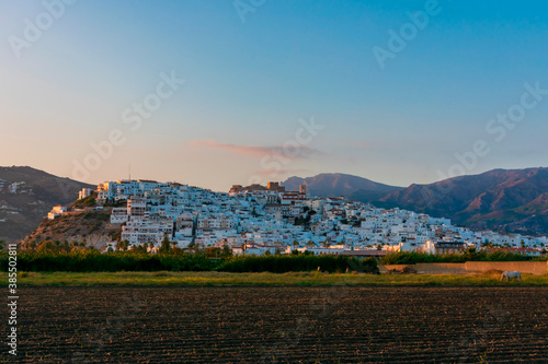 Salobreña, Andalusian town with white houses on a small mountain with a castle on top.