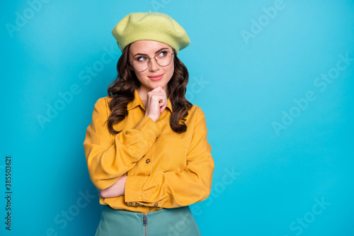 Portrait of minded pretty smart lady touch chin finger look copyspace think thoughts decide choose decision choice isolated over blue color background © deagreez
