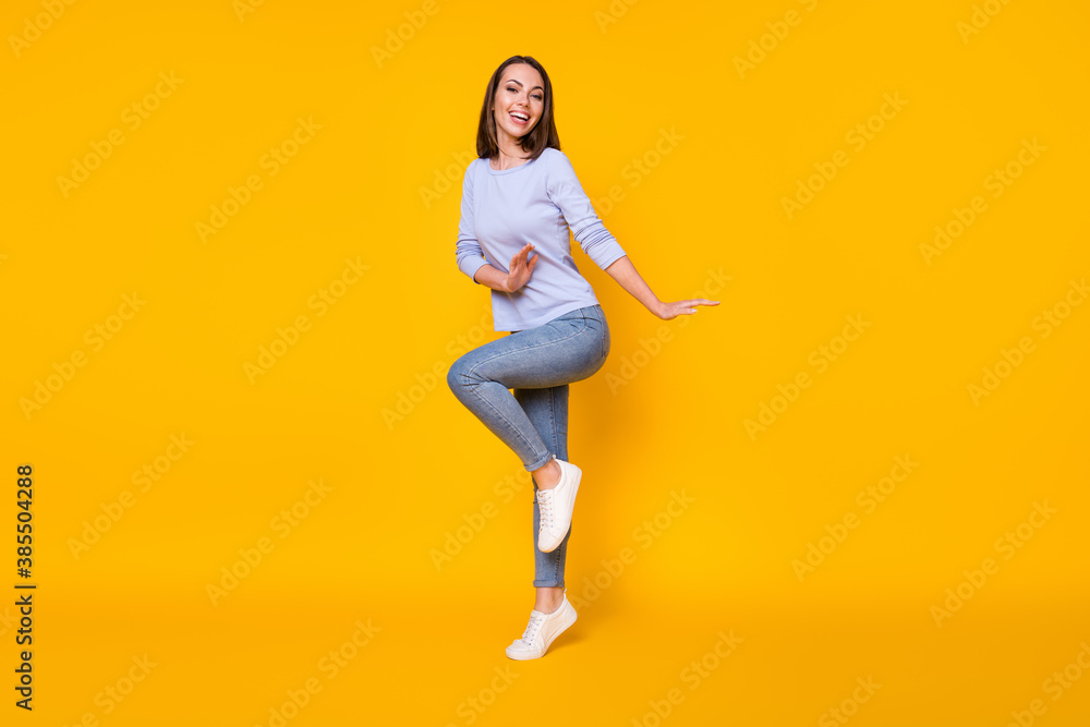 Full length body size view of her she nice attractive pretty girlish cheerful cheery girl jumping having fun dancing good mood spring isolated bright vivid shine vibrant yellow color background