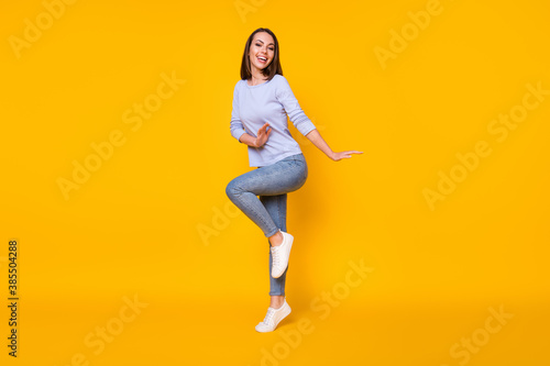 Fototapeta Naklejka Na Ścianę i Meble -  Full length body size view of her she nice attractive pretty girlish cheerful cheery girl jumping having fun dancing good mood spring isolated bright vivid shine vibrant yellow color background