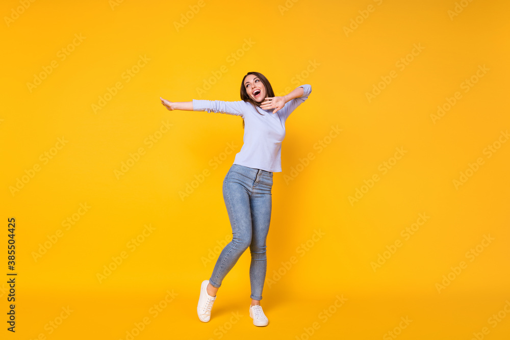 Full length body size view of her she attractive pretty slender careless cheerful cheery girl having fun dancing spending weekend isolated bright vivid shine vibrant yellow color background