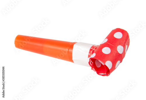 Rolled festive noisemaker or party whistle horn on the white