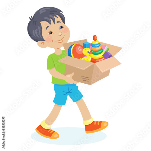 Kids toys. A funny boy is walking with a big box of toys in his hands. In cartoon style. Isolated on white background. Vector flat illustration.