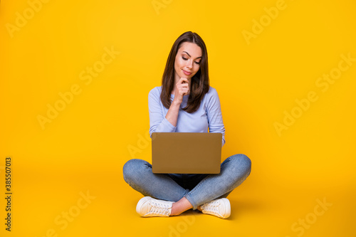 Full body photo of minded pensive girl sit floor legs crossed work remote laptop think thoughts report document wear style stylish violet clothes isolated bright shine color background © deagreez