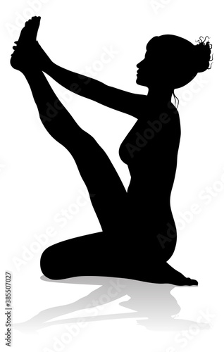 A silhouette of a woman in a yoga or pilates pose