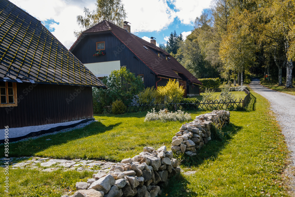 Houses in the village, the road to the forest. Sumava national park ...