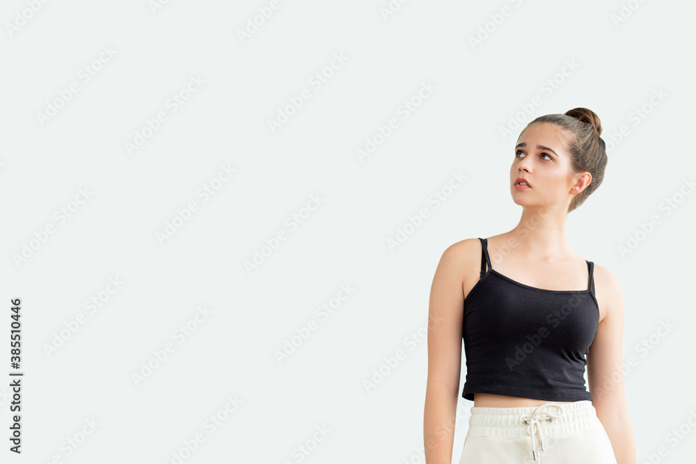 Puzzled woman. Unexpected information. Doubtful pretty lady in black sleeveless top white sportive trousers looking copy space isolated on neutral. Think about problem. Advertising background Puzzled woman. Unexpected information. Doubtful pretty lady in black sleeveless top white sportive trousers looking copy space isolated on neutral. Think about problem. Advertising background
