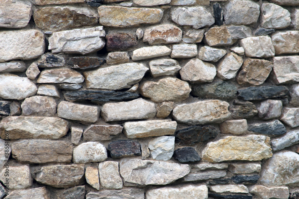 Stone wall texture.
Serbian rural house wall made of natural stones background. Close up on stone wall surface.