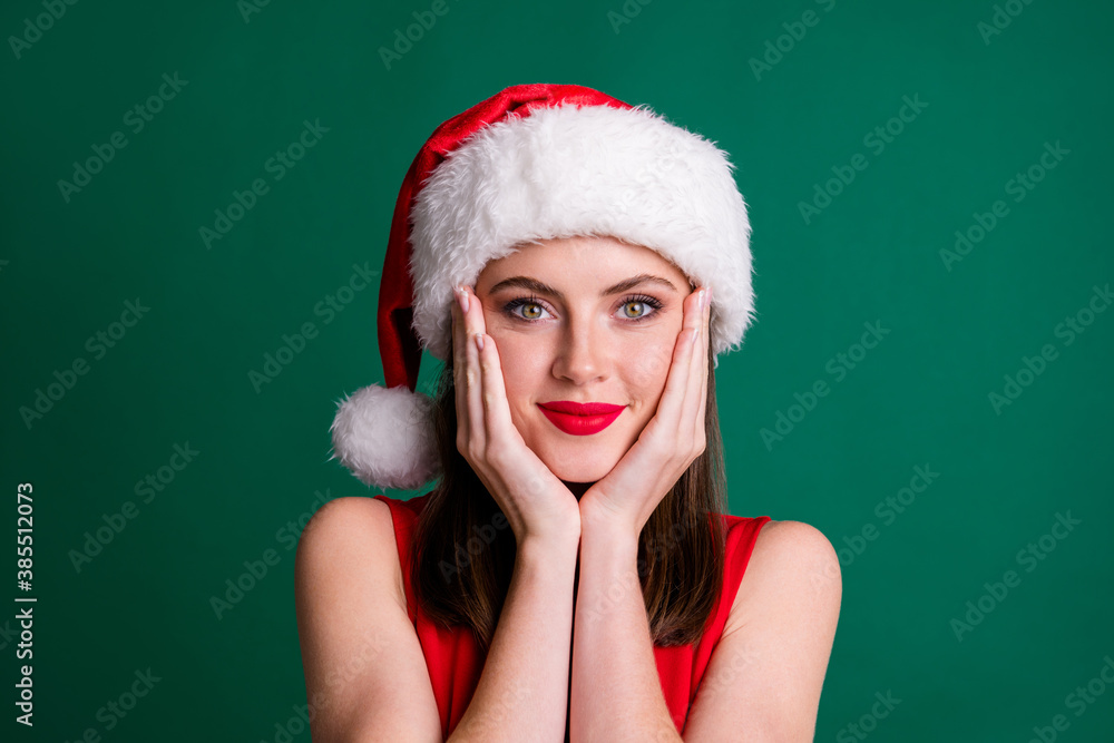 Closeup photo of attractive charming x-mas lady red lipstick look camera arms cheekbones face christmas dreamer atmosphere overjoyed wear santa cap isolated green pastel color background Closeup photo of attractive charming x-mas lady red lipstick look camera arms cheekbones face christmas dreamer atmosphere overjoyed wear santa cap isolated green pastel color background