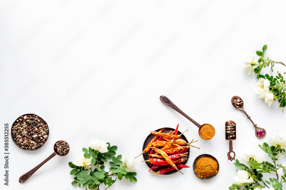 Hot spices set with herbs and flowers, top view Hot spices set with herbs and flowers, top view