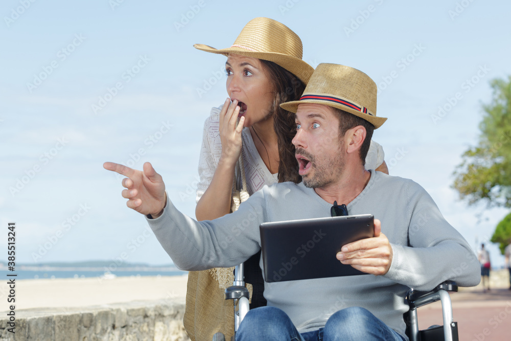 couple in wheelchair looking surprised at women