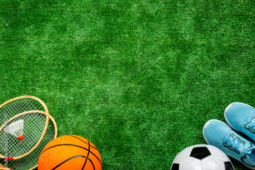 Sport games equipment on football field - balls, sneakers, rackets. Top view © 9dreamstudio