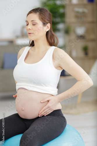 Free Download pregnant woman is relaxing at home - GFXLoad