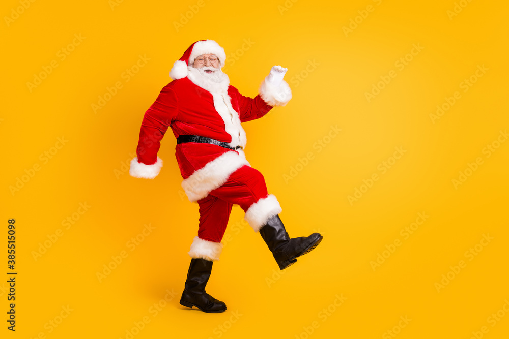 Full length body size view of his he nice funny cheerful cheery thick white-haired Santa St Nicholas walking having fun isolated bright vivid shine vibrant yellow color background Full length body size view of his he nice funny cheerful cheery thick white-haired Santa St Nicholas walking having fun isolated bright vivid shine vibrant yellow color background