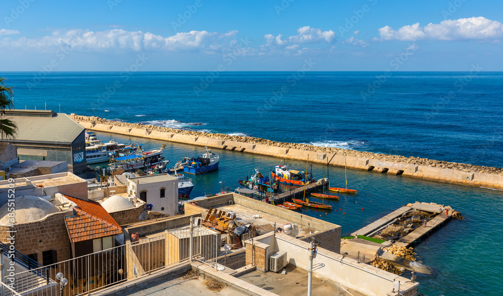 Panoramic view of yacht port and marina at Mediterranean coastline beneath Old City of Jaffa in Tel Aviv Yafo, Israel