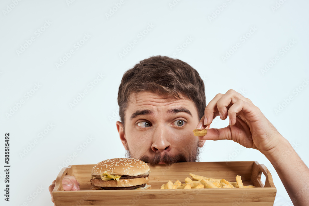 man with wooden tray fries and hamburger fast food calories model white t-shirt man with wooden tray fries and hamburger fast food calories model white t-shirt