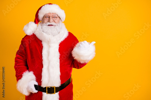 Excited holly fat santa claus with big abdomen point thumb copyspace demonstrate x-mas christmas magic discount ads wear cap headwear belt isolated bright shine color background