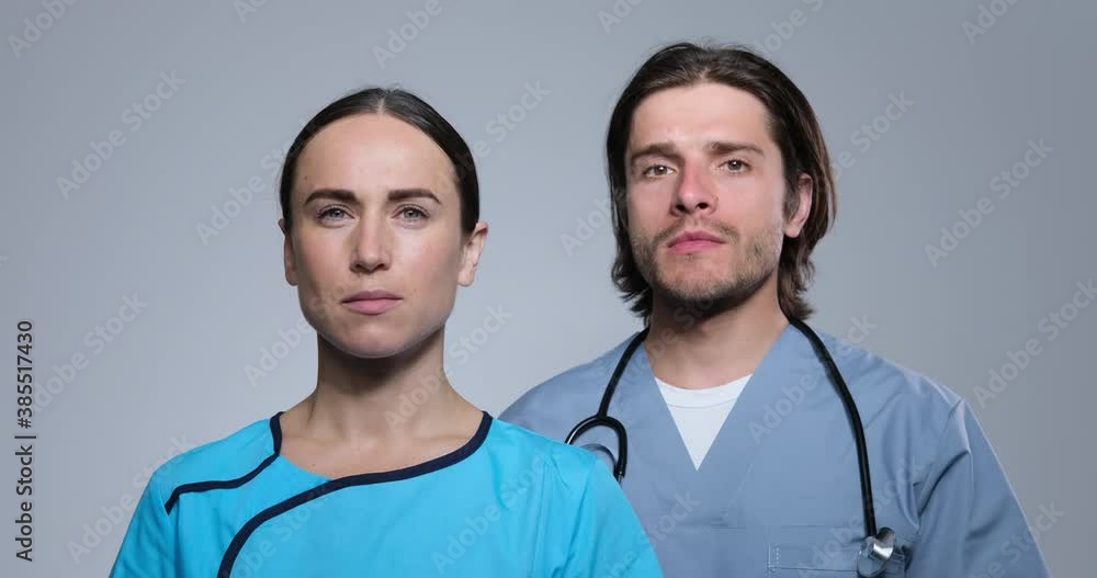 Confident male and female medical doctors over white background Confident male and female medical doctors over white background