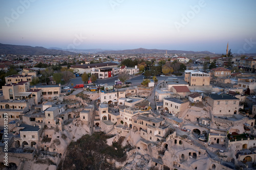 The city of Ortahisar with old houses, top view. Sunset sky in the background. Cappadocia, Turkey.