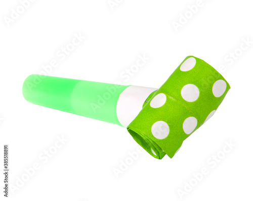 Rolled green in dots festive noisemaker or party whistle horn on the white isolated