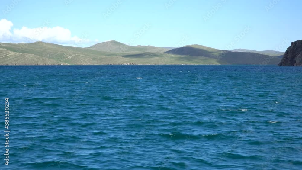 Cape on lake, rocky coast. concept of travel. Beautiful landscape of Siberian Baikal Lake. Panoramic view. Lake Baikal is the largest freshwater lake in the world. Natural background. Cape on lake, rocky coast. concept of travel. Beautiful landscape of Siberian Baikal Lake. Panoramic view. Lake Baikal is the largest freshwater lake in the world. Natural background.