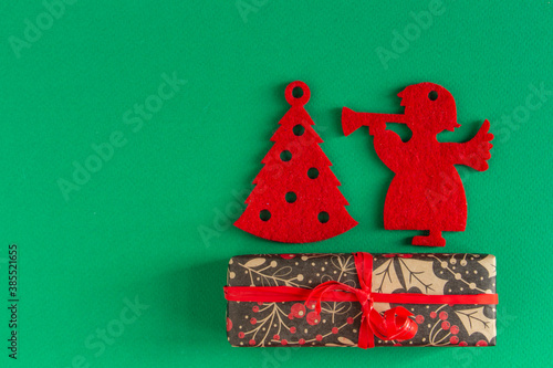  children's Christmas, New Year card - red felt toys and gifts on a green background. Flat lay, copy space, top view