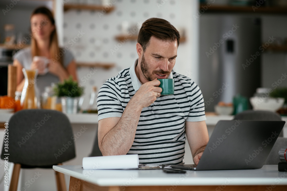 Young man working on project. Handsome man working at home. Young man working on project. Handsome man working at home.