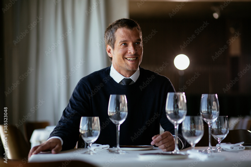 Handsome businessman drinking wine. Businessman enjoying in the restaurant Handsome businessman drinking wine. Businessman enjoying in the restaurant
