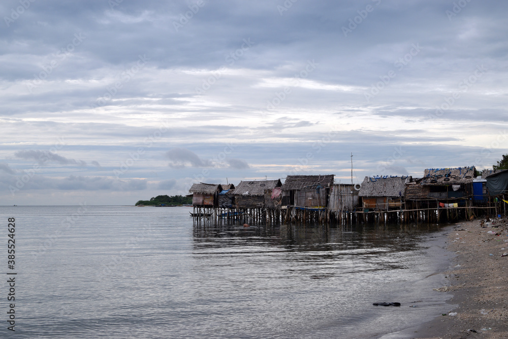 Over water stilt Bajau shanty houses built by indigenous people in the philippines. Long shot