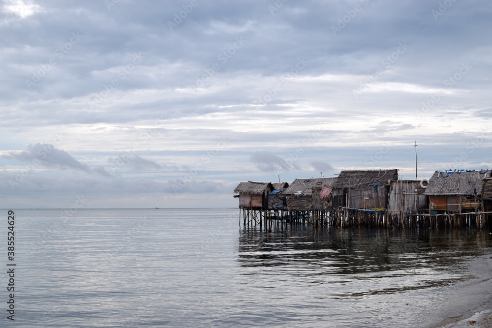 Over water stilt Bajau shanty houses built by indigenous people in the philippines. Long shot Over water stilt Bajau shanty houses built by indigenous people in the philippines. Long shot