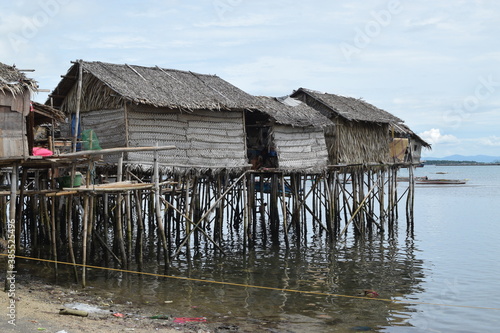 Bamboo poles support the stilt Bajau shanty houses built by indigenous people in the philippines. lmedium long shot © Renato