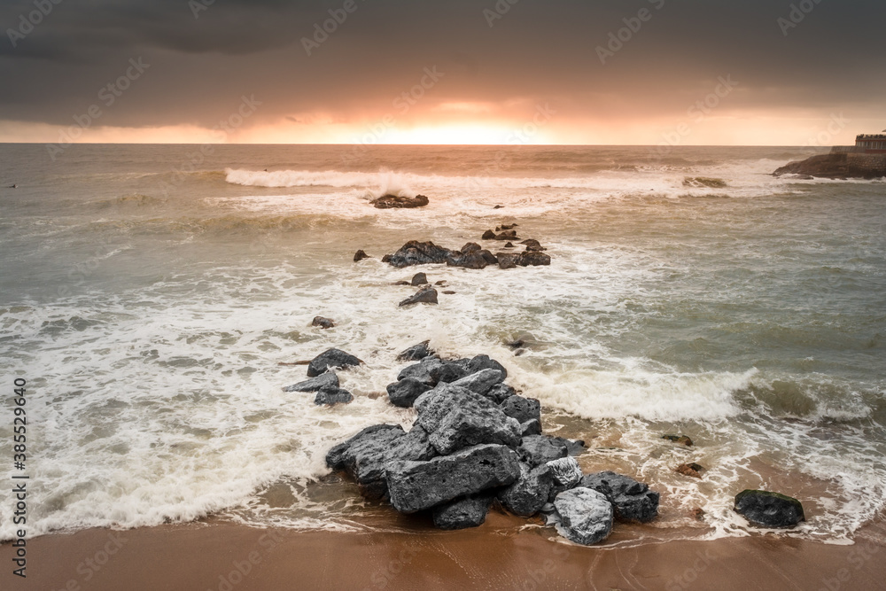 Fototapeta premium Sunset landscapes facing the sea with stones at Ericeira beach, Portugal
