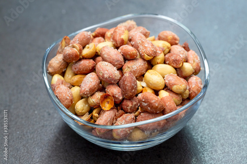 Salted peanuts in a glass bowl