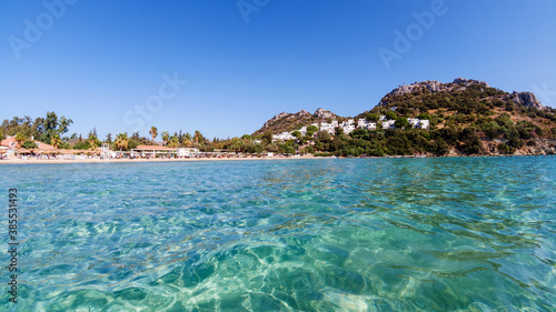 Clear turquoise water of Aegean sea and Caraincir beach. Beautiful Mediterranean seascape of ripple water with sunbeams reflections. Province of Mugla, Datca peninsula, Turkey 