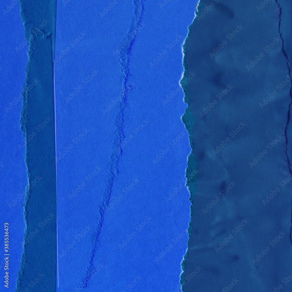 Fototapeta premium Blue torn paper collage close-up. Texture made from various paper and cardboard parts. Damaged old paper background. Vintage blank wallpaper. Material design backdrop.