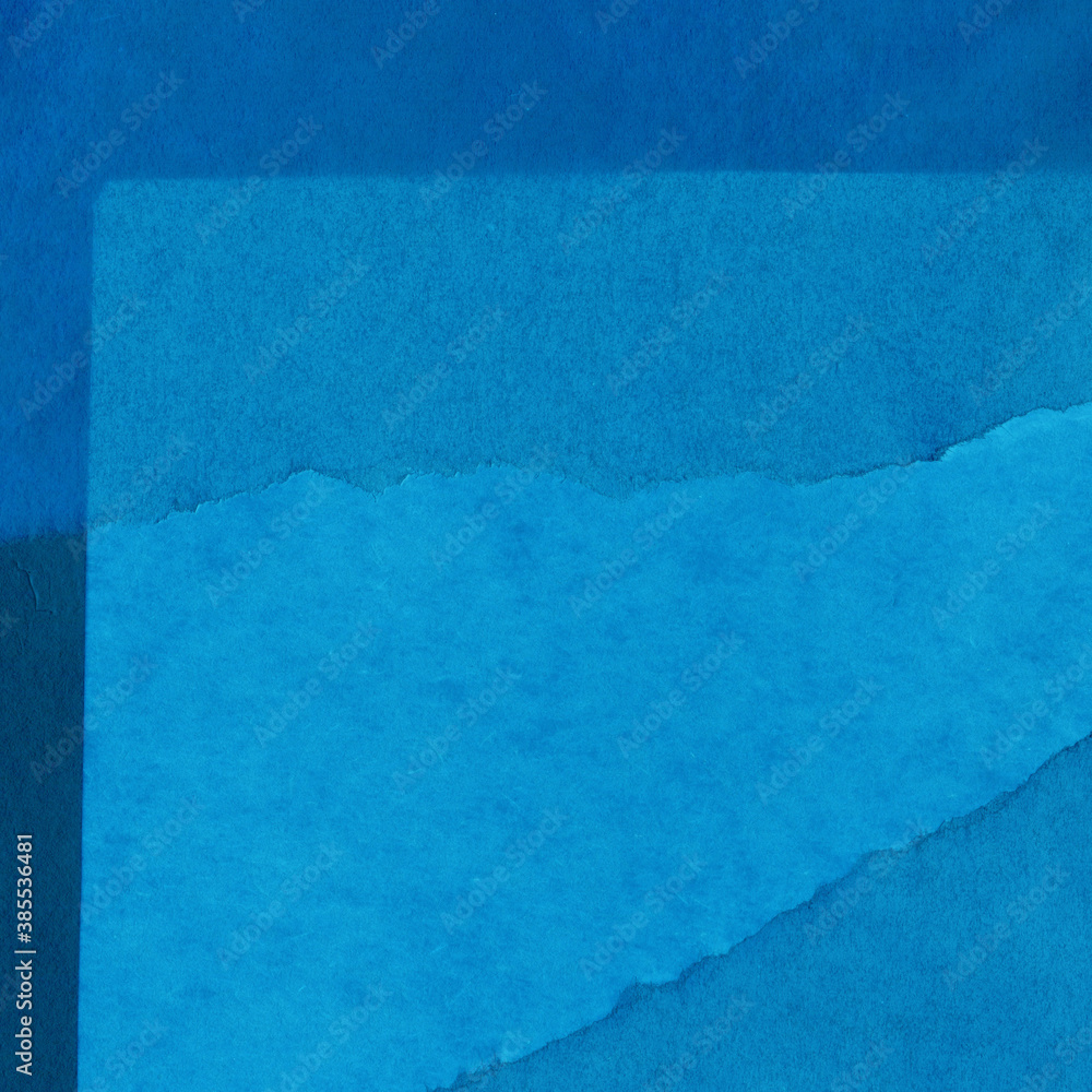 Blue torn paper collage close-up. Texture made from various paper and cardboard parts. Damaged old paper background. Vintage blank wallpaper. Material design backdrop. Blue torn paper collage close-up. Texture made from various paper and cardboard parts. Damaged old paper background. Vintage blank wallpaper. Material design backdrop.