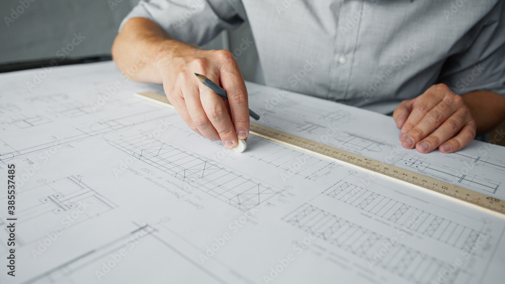 Architect's hands making a drawing Architect's hands making a drawing