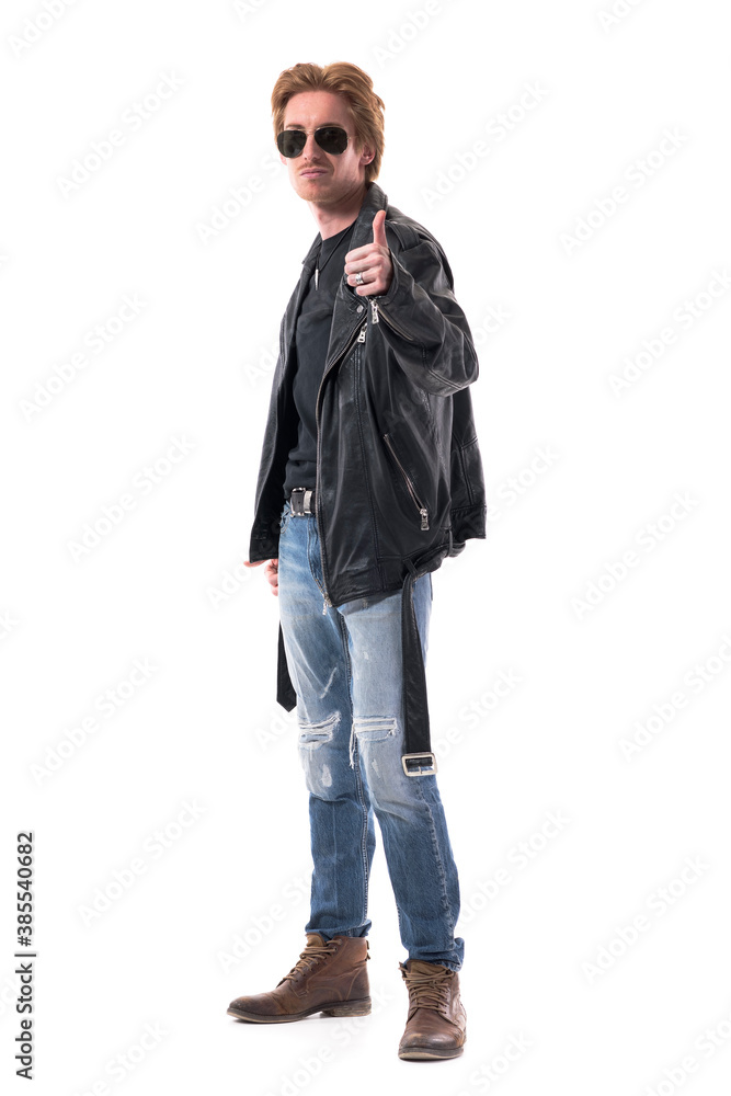 Confident handsome redhead man with sunglasses in leather jacket showing thumbs up like gesture. Full body isolated on white background. Confident handsome redhead man with sunglasses in leather jacket showing thumbs up like gesture. Full body isolated on white background.